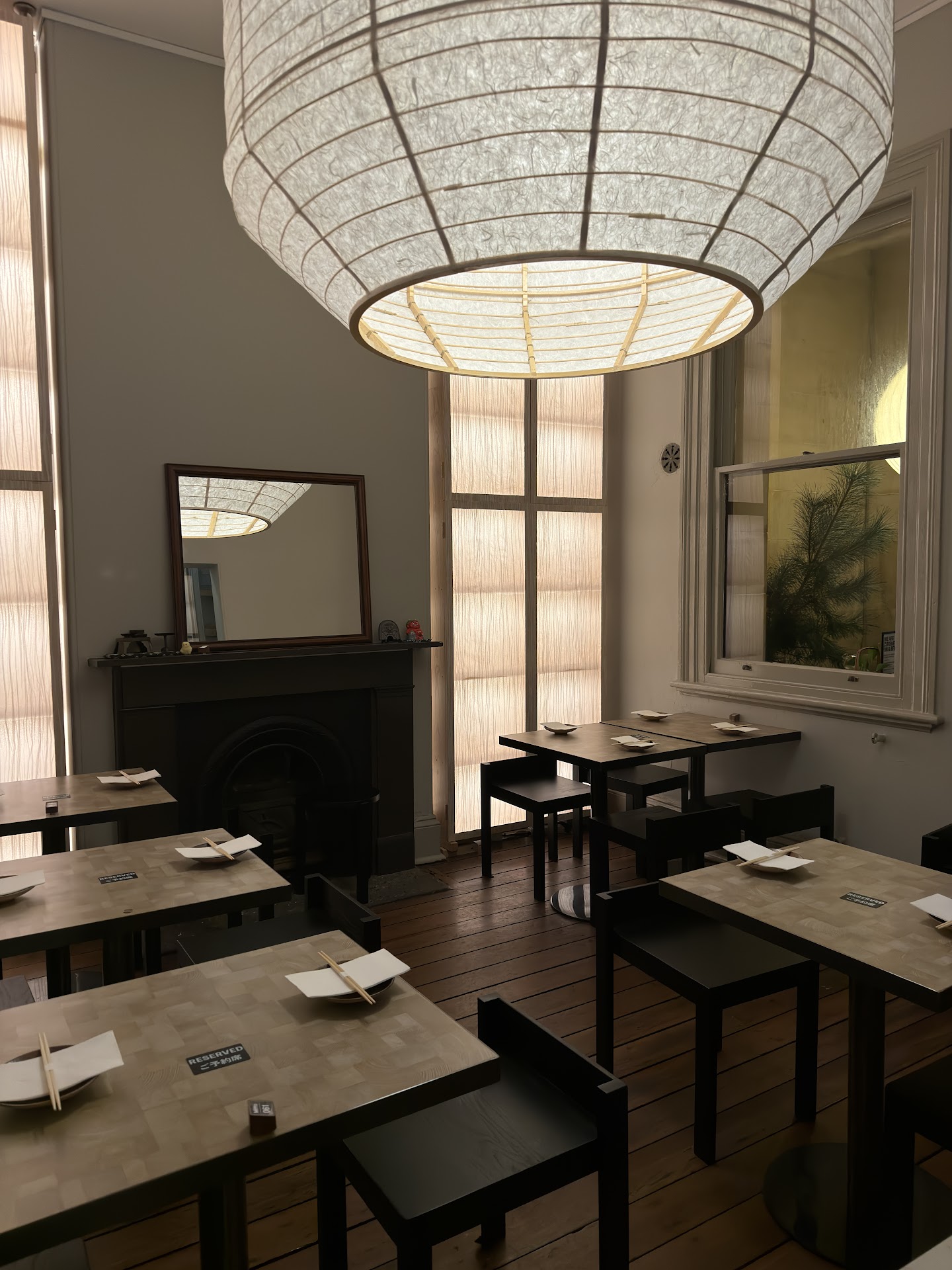 The dining room inside Izakaya Mitto with paper lantern lighting